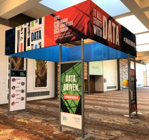 Event exhibit with color printed fabric branding signage supported by custom color graphic displays at Inmar Analytics Forum