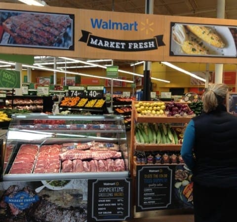 Walmart employees converse before custom Walmart Market Fresh custom fabricated indoor produce stand
